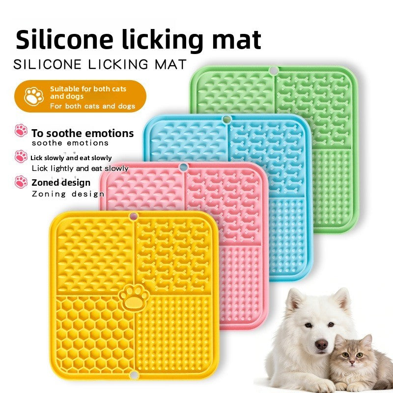 The dog licks the pet feeding pad on the table.
